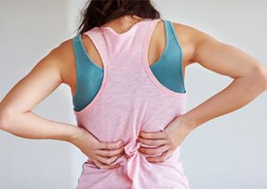 woman holding her lower back