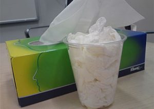 tissue paper box and cup filled with used tissues