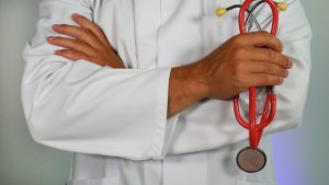 doctor holding a red stethoscope